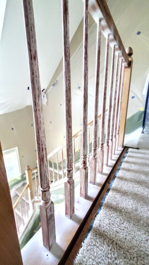 Eugene Painter fills grains of wood before sanding again for Stairway 